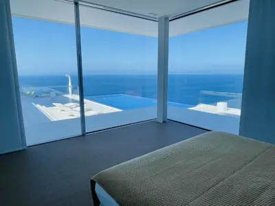 a kitchen with white cabinets and an empty refrigerator at Villa Camacho - Ultra Luxury in Calheta
