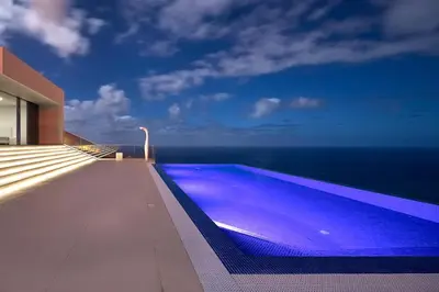 a bedroom with a view of a swimming pool at Villa Camacho - Ultra Luxury in Calheta