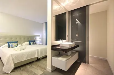 a bedroom with a bed with a sink and a mirror at Villa Camacho iv - Mansion House in Arco da Calheta