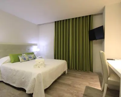 a bedroom with two beds with blue pillows at Villa Camacho iv - Mansion House in Arco da Calheta
