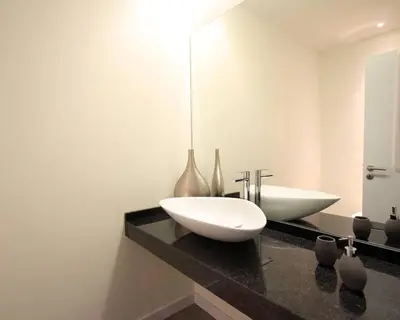 a bathroom with a white sink and a mirror at Villa Camacho iv - Mansion House in Arco da Calheta