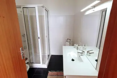 a white bathroom with a shower and a sink at Ocean View Madeira 3 - Ponta do Sol in Canhas