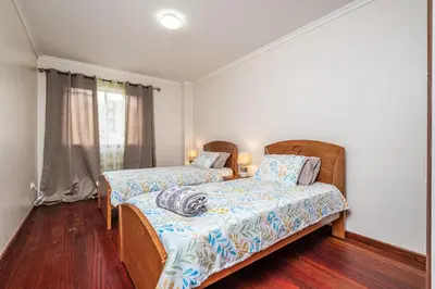a bedroom with two beds and a window at Bela Vista Sea View in Venda do Atalhinho