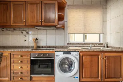 a kitchen with a washing machine and a sink at Bela Vista Sea View in Venda do Atalhinho