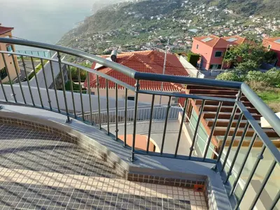 a metal staircase with a view of a city at Beautiful View 2 - Arco da Calheta - Ilha da Madeira in Arco da Calheta