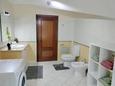 a bathroom with a toilet and a sink and a door at Beautiful View 2 - Arco da Calheta - Ilha da Madeira in Arco da Calheta