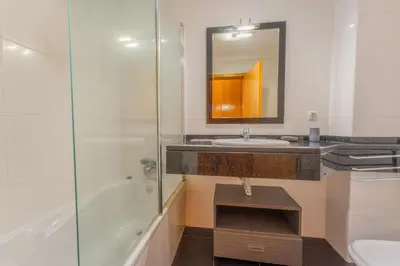 a bathroom with a sink and a shower and a mirror at FLH Garajau Fantastic Ocean View with Balcony in Funchal