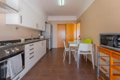a kitchen with a table and a microwave at FLH Garajau Fantastic Ocean View with Balcony in Funchal
