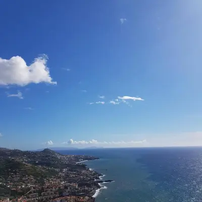 an aerial view of the ocean and a city at Sunset House in Câmara de Lobos