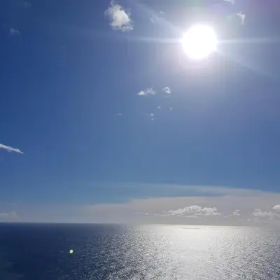 a view of the ocean with the sun in the sky at Sunset House in Câmara de Lobos