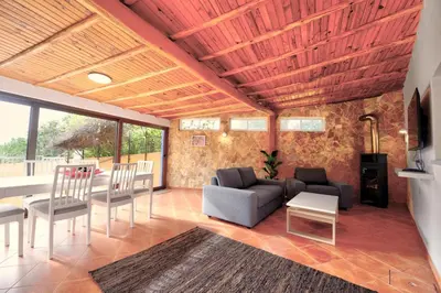 a living room with a couch and a table and chairs at The Secret Corner of Luz in Luz
