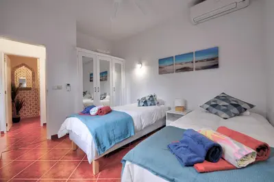 a bedroom with two beds with towels on them at The Secret Corner of Luz in Luz