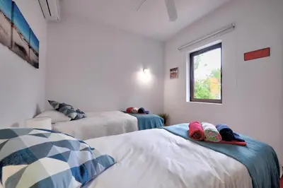 a bedroom with two beds and a window at The Secret Corner of Luz in Luz