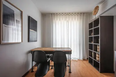 a dining room with a table and two chairs at Portola Penthouse by YMR in Funchal