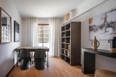 a dining room with a table and two chairs at Portola Penthouse by YMR in Funchal