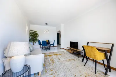 a living room with a couch and a table at Apartment Henry Matisse, swimming pool in Sagres