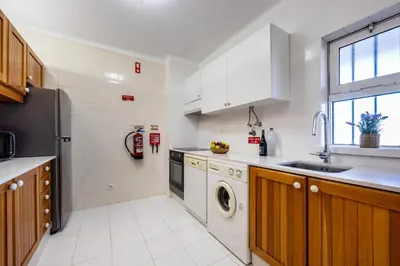 a kitchen with a sink and a dishwasher at Apartment Henry Matisse, swimming pool in Sagres