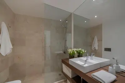 a bathroom with a sink and a large mirror at Madalenas XXI by An Island Apart in Funchal