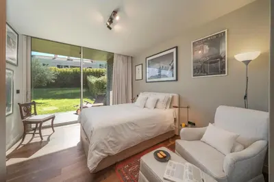 a bedroom with a bed and a chair and a couch at Savoy Residence Casa Branca I by An Island Apart in Funchal