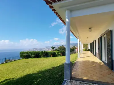 a porch of a house with a view of the ocean at Neves by BCA Villas in Funchal