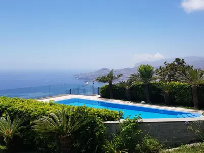 a swimming pool with a view of the ocean at Neves by BCA Villas in Funchal