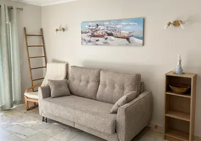 a living room with a couch and a painting on the wall at Lagos Apartment Sea View in Lagos