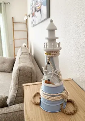 a model of a lighthouse sitting on a coffee table at Lagos Apartment Sea View in Lagos
