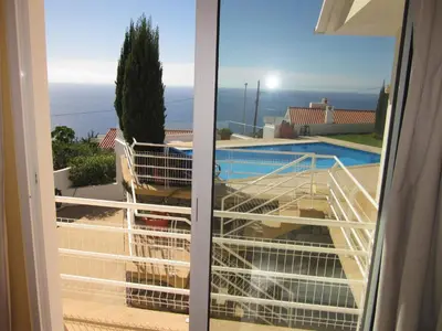 a balcony with a view of a swimming pool at Villa Hansen in Garajau - Cristo Rei in Caniço
