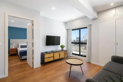 a living room with a bed and a tv at Atlantic Blue 1 - central and with garage in Funchal