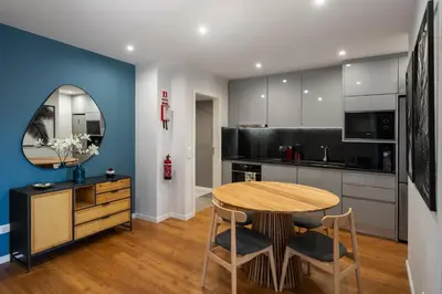 a kitchen with a wooden table and a dining room at Atlantic Blue 1 - central and with garage in Funchal