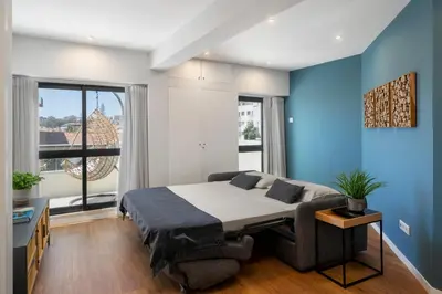 a bedroom with a bed and a blue wall at Atlantic Blue 1 - central and with garage in Funchal