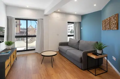 a living room with a couch and a table at Atlantic Blue 1 - central and with garage in Funchal
