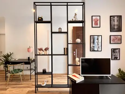 a living room with a black shelving unit at Eva Boutique Apartment in Funchal
