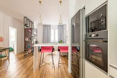 a kitchen and dining room with a table and a fireplace at Eva Boutique Apartment in Funchal