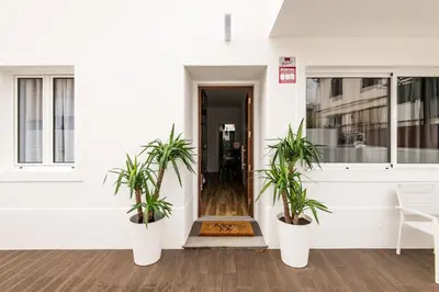 a hallway with two potted plants in front of a building at Eva Boutique Apartment in Funchal