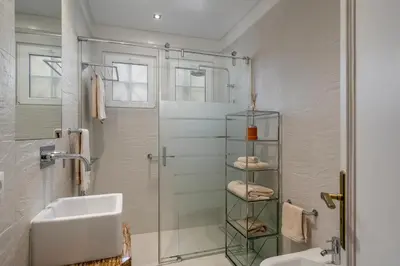 a bathroom with a shower and a sink and a mirror at OurMadeira - Vista Grande in Caniço