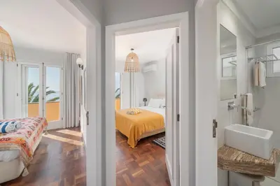 a bedroom with a bed and a bathroom with a tub at OurMadeira - Vista Grande in Caniço