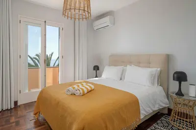 a bedroom with a bed with two towels on it at OurMadeira - Vista Grande in Caniço