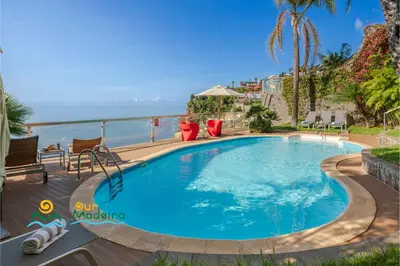 a swimming pool with a view of the ocean at OurMadeira - Vista Grande in Caniço
