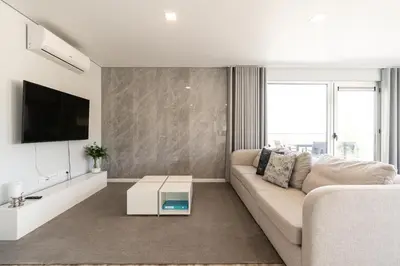 a living room with a couch and a tv at Casa Alan by Rent2u, Lda in Arco da Calheta