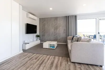 a living room with a couch and a tv at Casa Alan by Rent2u, Lda in Arco da Calheta