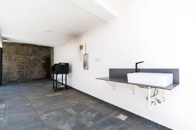 a bathroom with a sink on a wall at Casa Alan by Rent2u, Lda in Arco da Calheta