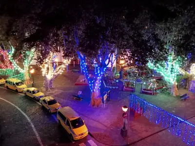 a group of cars parked in a parking lot with christmas lights at Machico Centre Comfort in Machico