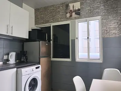 a kitchen with a refrigerator and a washer at Machico Centre Comfort in Machico