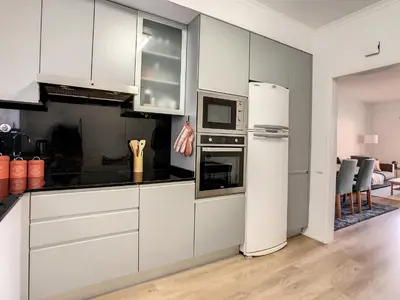 a kitchen with white cabinets and a white refrigerator at Casa Pico dos Barcelos by LovelyStay in Funchal