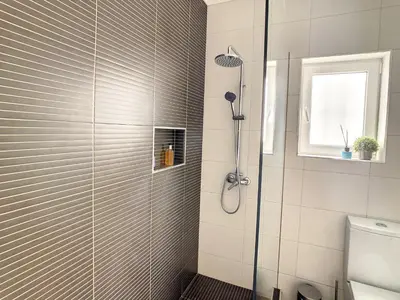 a shower with a glass door in a bathroom at Casa Pico dos Barcelos by LovelyStay in Funchal