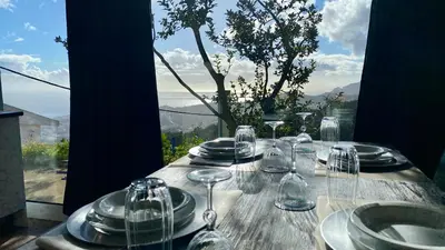 a wooden table with wine glasses and plates on it at Studio Geek Villa - Open Space - 5m from 5 top attractions - Pool all year round, Dining Pergola, Barbecue - Funchal Matrix Holiday Home in Funchal