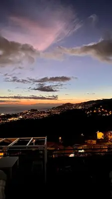 a view of a city at sunset at Studio Geek Villa - Open Space - 5m from 5 top attractions - Pool all year round, Dining Pergola, Barbecue - Funchal Matrix Holiday Home in Funchal