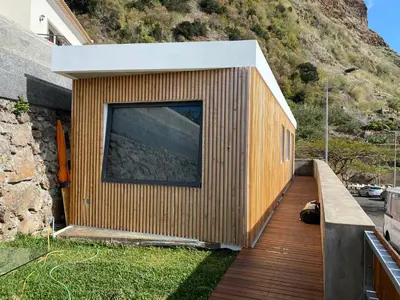a house with a large window on the side of it at CASA DA PITANGA in Jardim do Mar