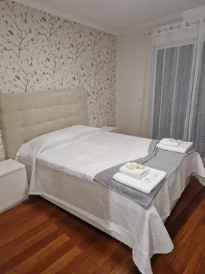 a bedroom with a bed with a tray of food on it at Cristinas 2 Bedroom Apartment Caniço in Caniço